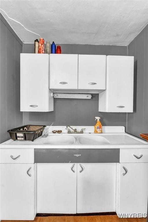 kitchen with white cabinetry and sink