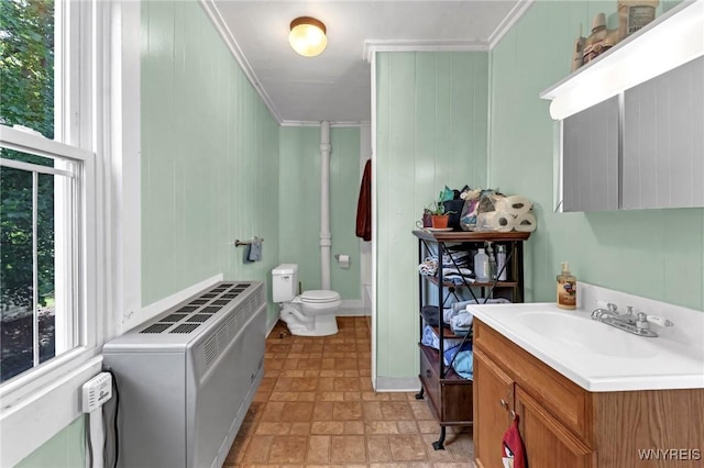 bathroom featuring vanity, toilet, and ornamental molding