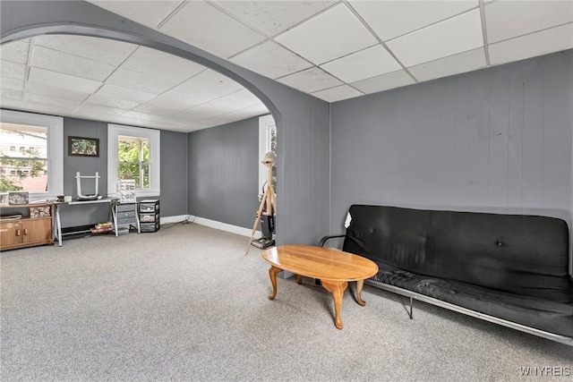 sitting room with a drop ceiling and carpet