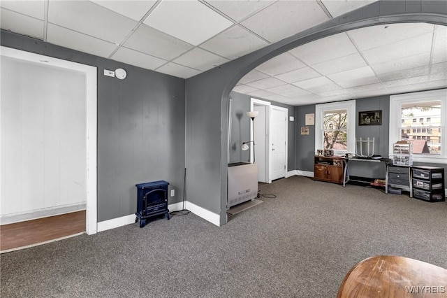 interior space with a drop ceiling and carpet floors