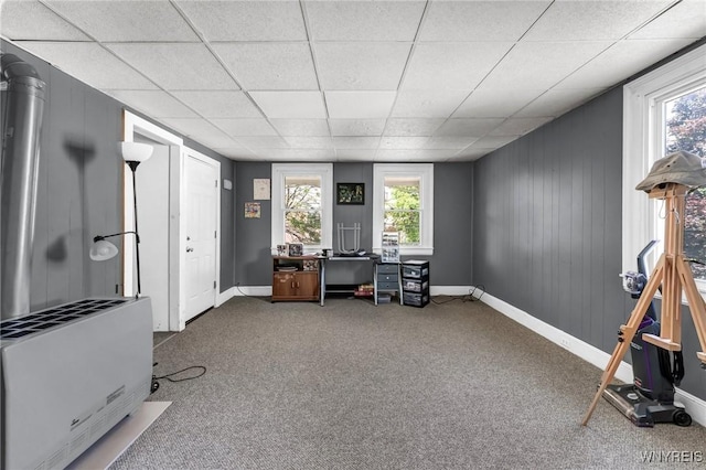 carpeted home office featuring a paneled ceiling, a wealth of natural light, and heating unit