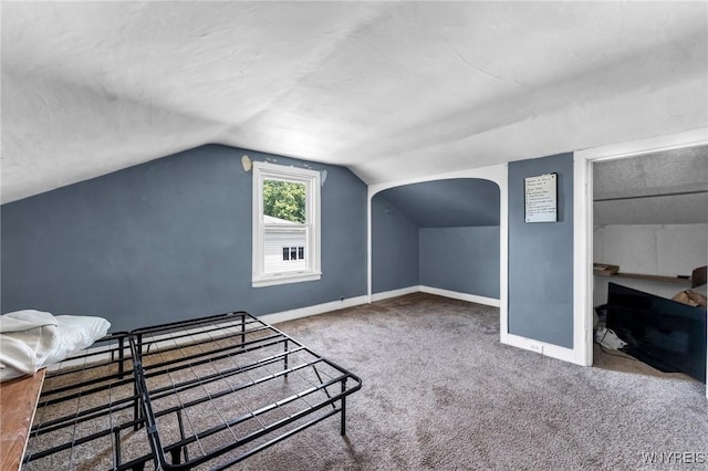 carpeted bedroom featuring lofted ceiling