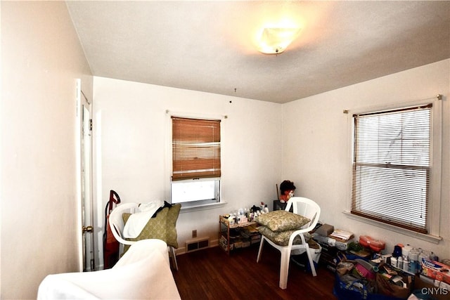 bedroom with dark hardwood / wood-style flooring