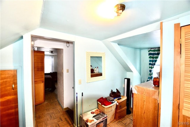 interior space featuring lofted ceiling and parquet flooring