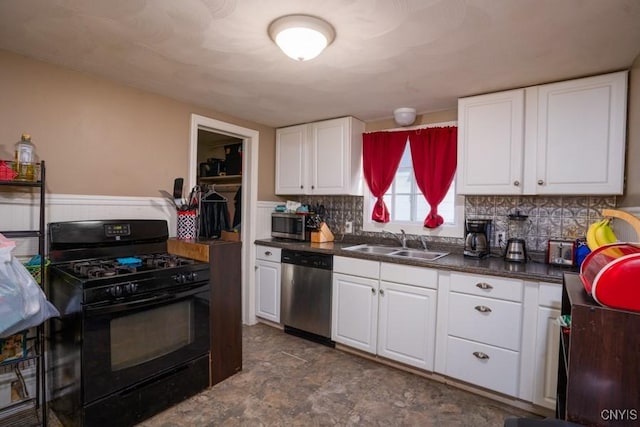 kitchen featuring stainless steel appliances, white cabinetry, and sink