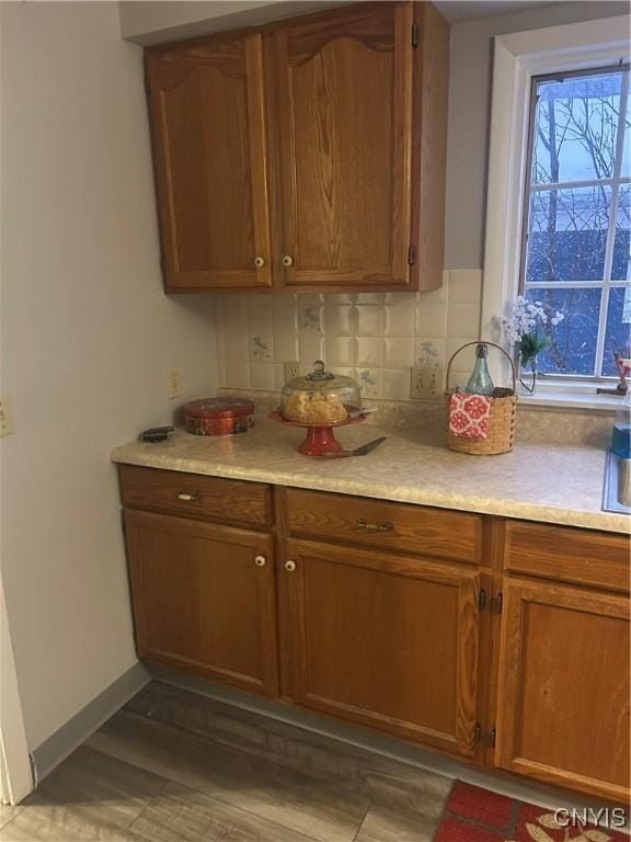 kitchen featuring decorative backsplash and light wood-type flooring