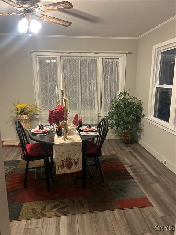 dining space with ceiling fan, wood-type flooring, and ornamental molding