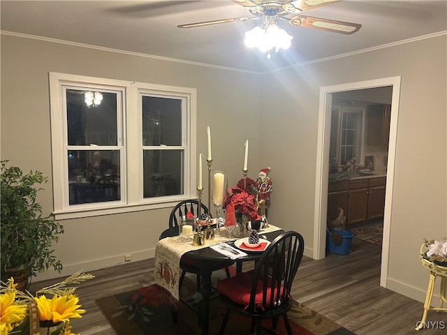 dining room with dark hardwood / wood-style floors, ceiling fan, and crown molding