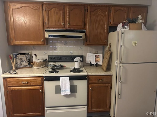 kitchen featuring ventilation hood, white appliances, and backsplash