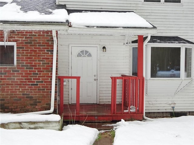 view of snow covered property entrance