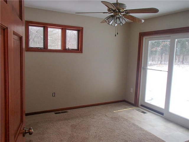 empty room featuring a healthy amount of sunlight and light colored carpet