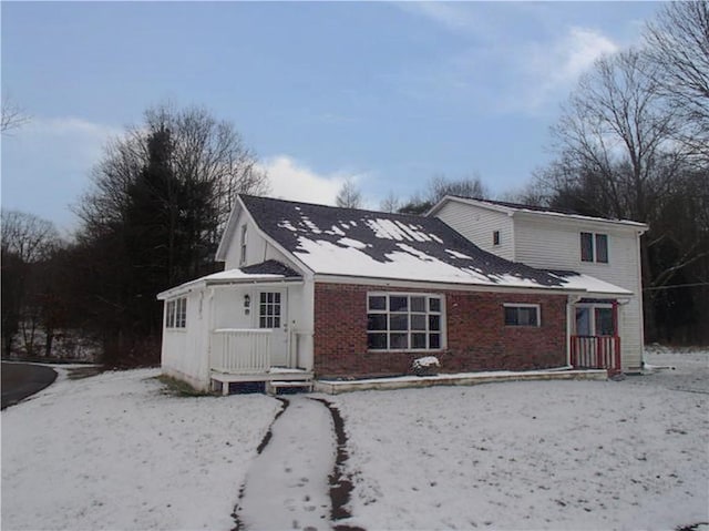 view of snow covered rear of property