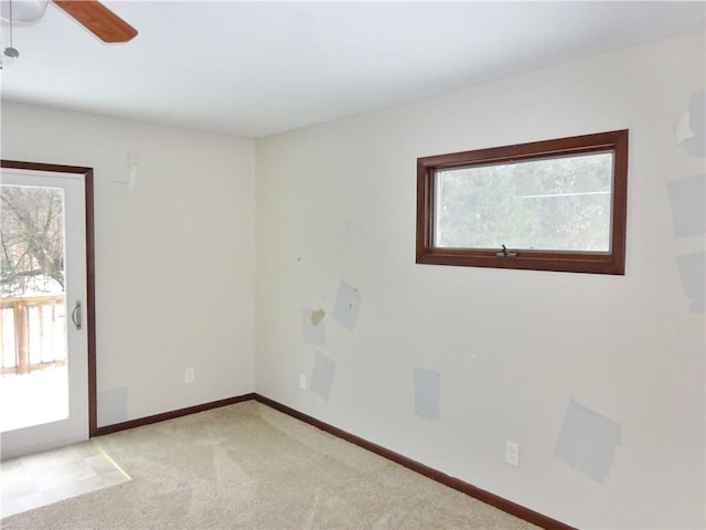 spare room featuring ceiling fan and light carpet