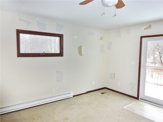 carpeted empty room featuring ceiling fan and a baseboard radiator