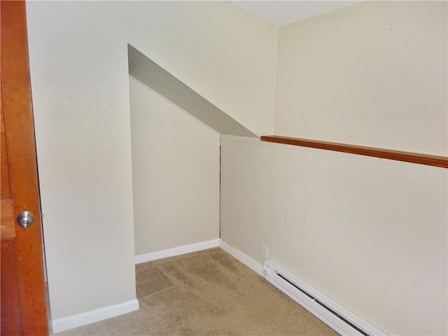 walk in closet with light colored carpet and a baseboard radiator