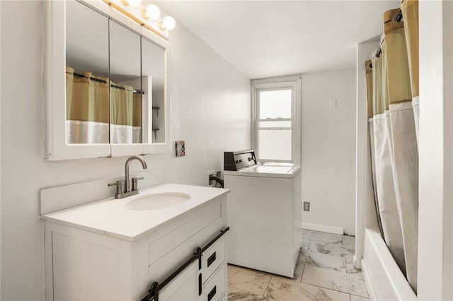 bathroom featuring vanity and washer / dryer