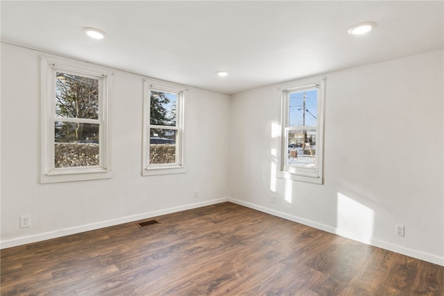 spare room featuring dark hardwood / wood-style floors