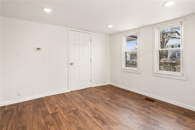 spare room with dark hardwood / wood-style flooring