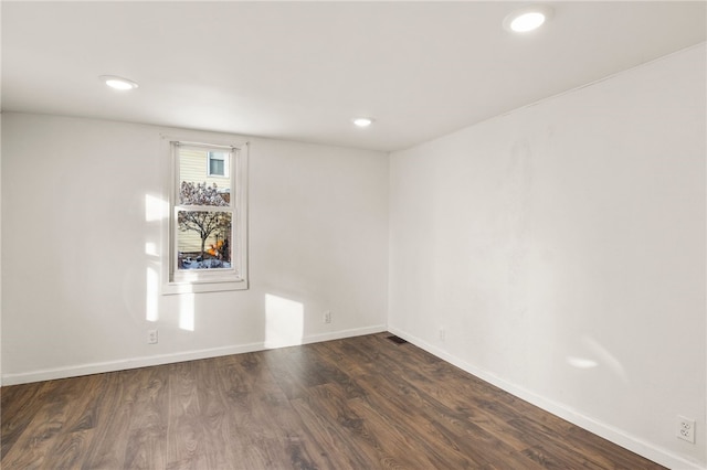 spare room with dark wood-type flooring