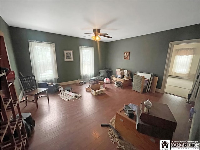 miscellaneous room featuring a ceiling fan, hardwood / wood-style floors, and baseboards