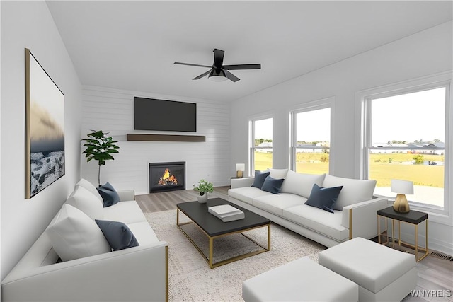 living room featuring plenty of natural light, light hardwood / wood-style floors, and ceiling fan