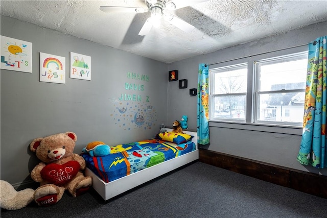 bedroom with carpet flooring, a textured ceiling, and ceiling fan