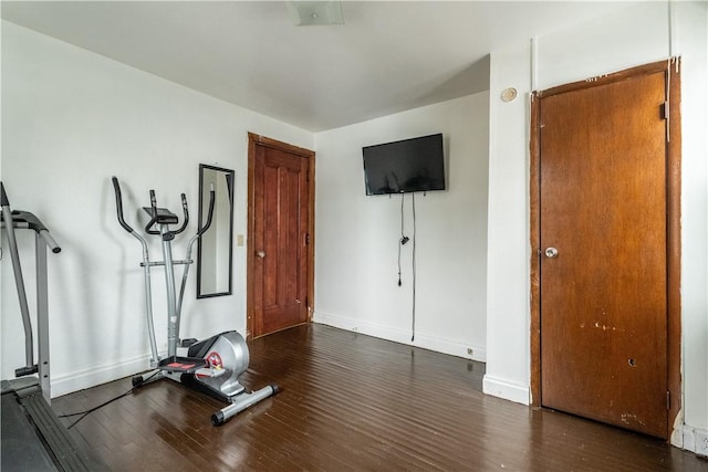 exercise room with dark hardwood / wood-style floors