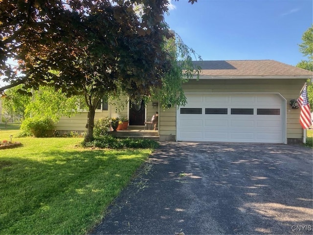 view of front of property with a front yard and a garage