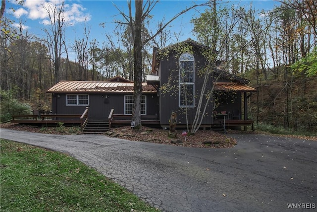 view of front facade featuring metal roof and a wooden deck