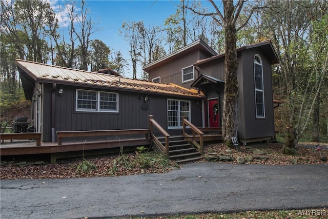 view of front of house with metal roof and a deck