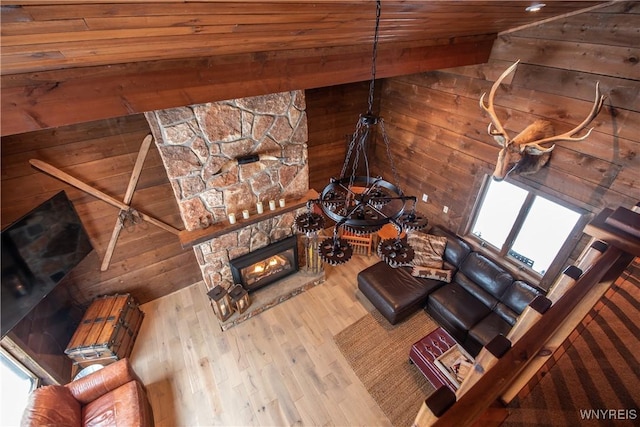 unfurnished living room featuring lofted ceiling, wooden walls, wood finished floors, and wooden ceiling