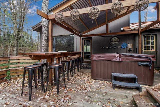 wooden deck featuring outdoor dry bar and a hot tub