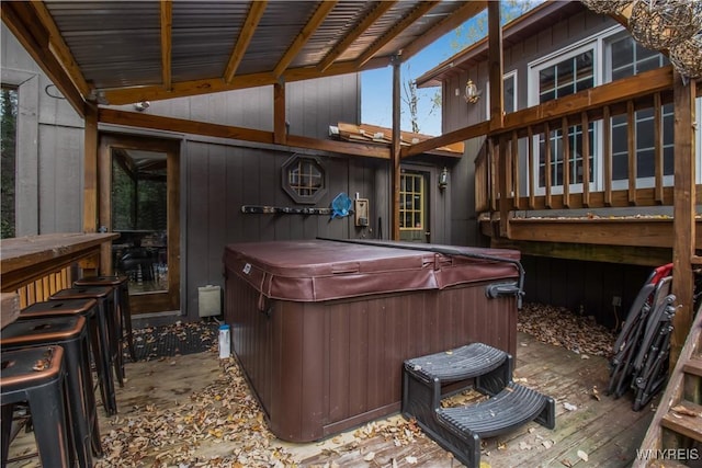 exterior space with a jacuzzi and wood finished floors