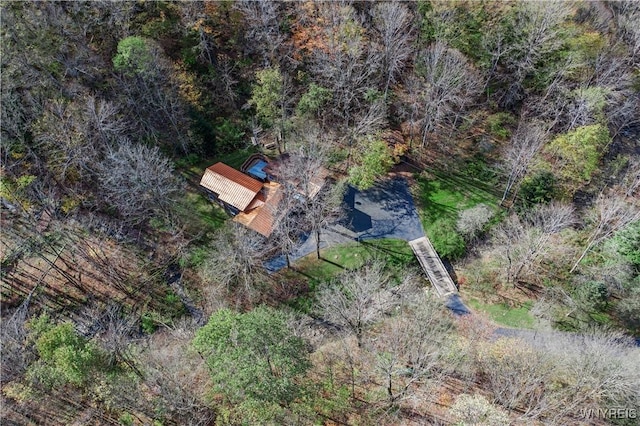 birds eye view of property featuring a view of trees