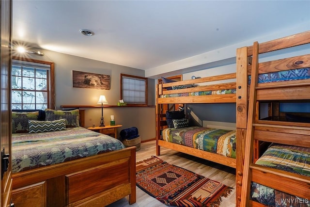 bedroom with visible vents and wood finished floors