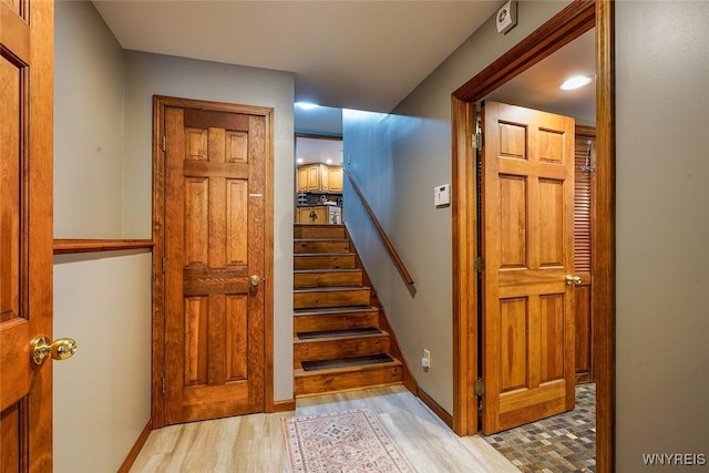 stairway featuring baseboards and wood finished floors