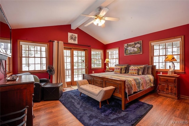 bedroom featuring ceiling fan, wood finished floors, vaulted ceiling with beams, and access to outside