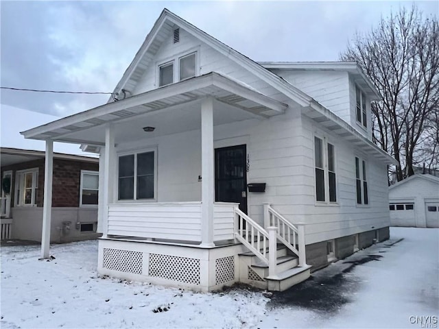 view of front of home with a garage and an outdoor structure