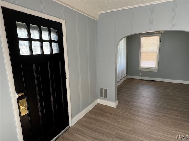 foyer entrance featuring hardwood / wood-style floors and crown molding