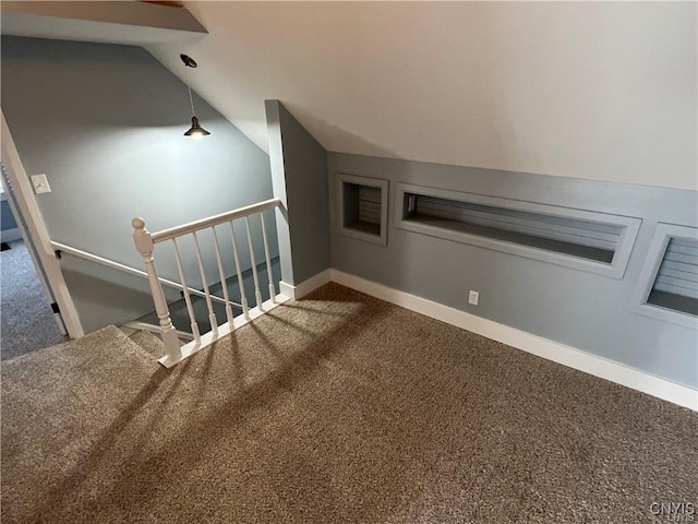 stairs with carpet flooring and vaulted ceiling