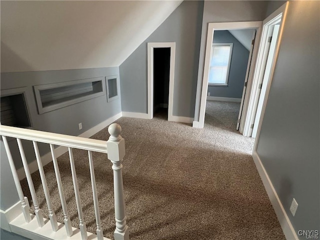 stairway featuring carpet and lofted ceiling