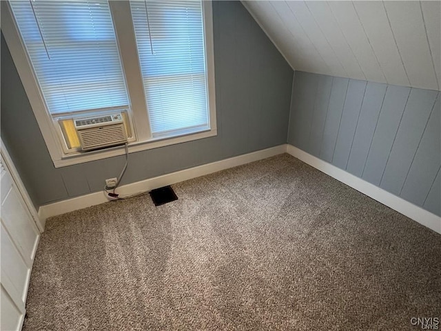 additional living space with carpet, cooling unit, and lofted ceiling