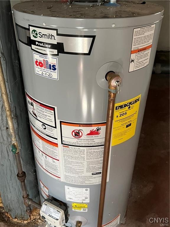 utility room featuring water heater