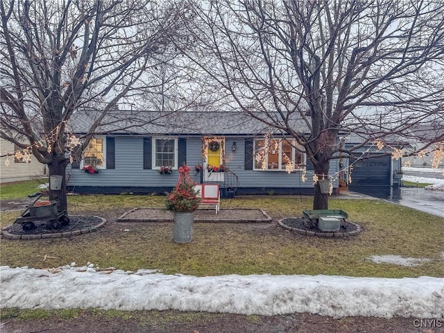 ranch-style home with a garage and a front yard