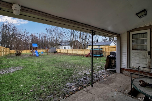 view of yard with a playground and a patio area