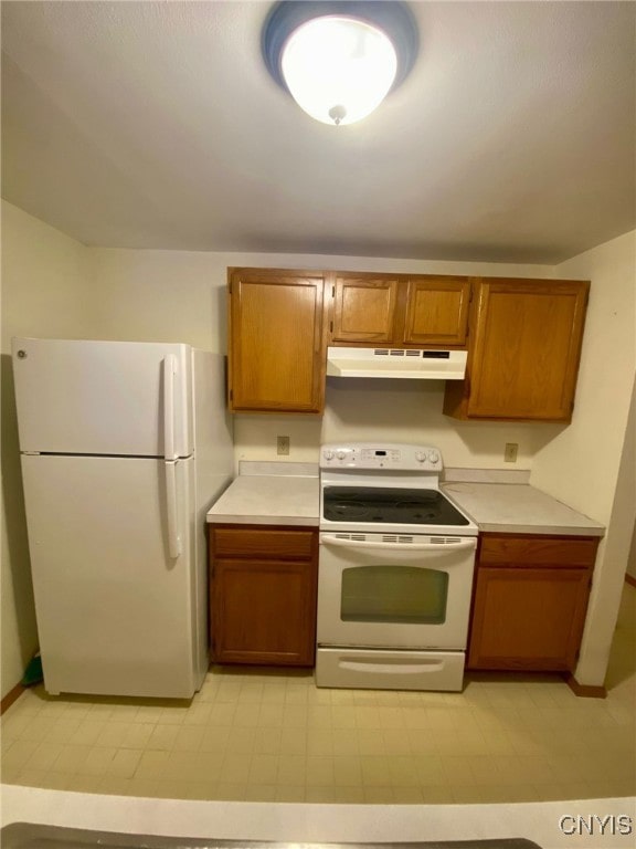 kitchen featuring white appliances and light tile patterned floors