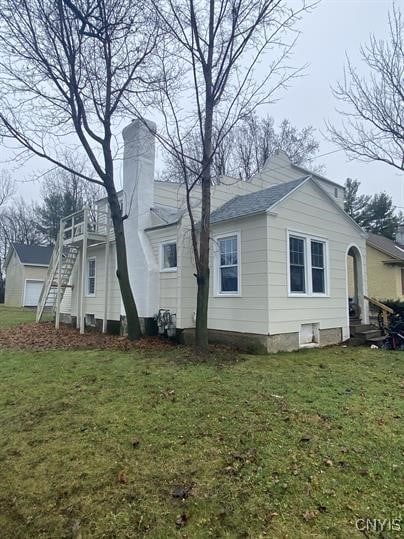 view of side of property with a lawn