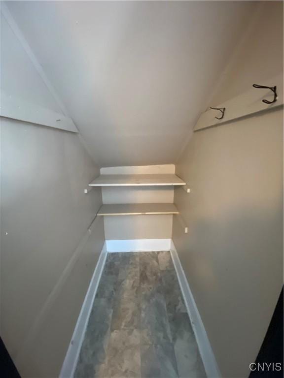 walk in closet featuring lofted ceiling