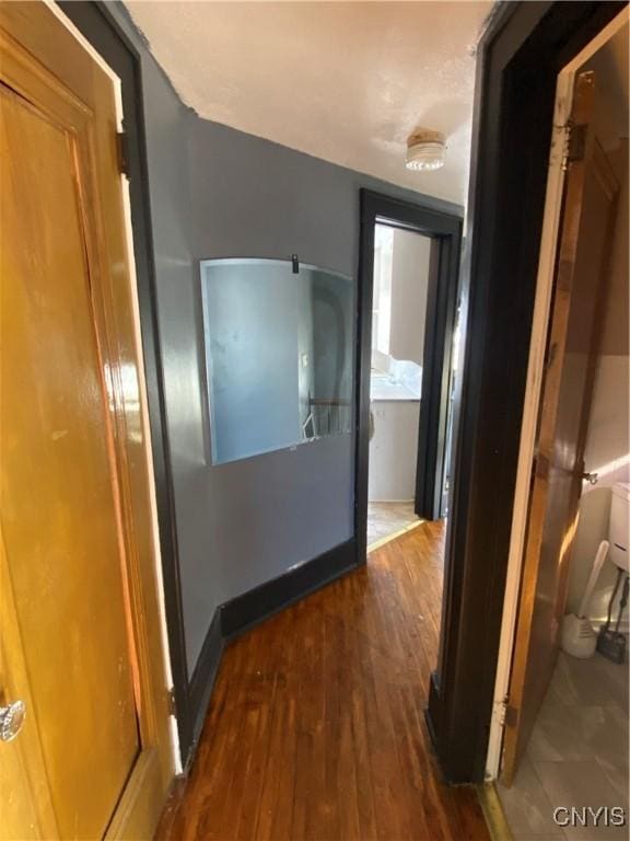 hallway with dark hardwood / wood-style floors