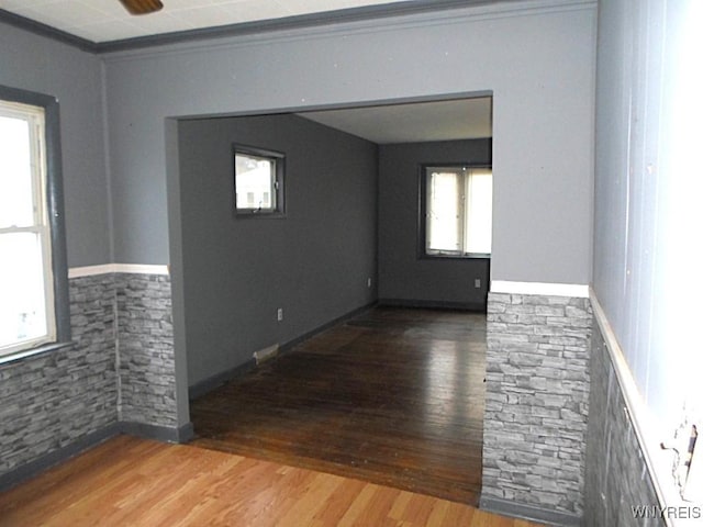 unfurnished room with hardwood / wood-style floors and ceiling fan